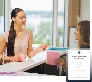 A patient setting up her Cherry payment plan at the Beauty Bungalow front desk